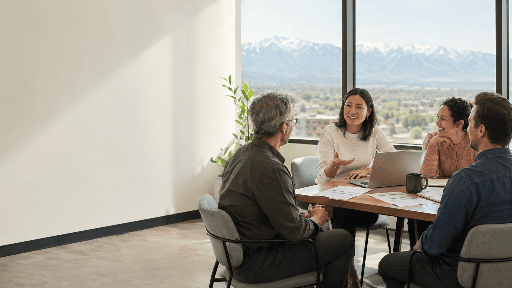 Utah small business team reviewing employee benefits options together in a bright office