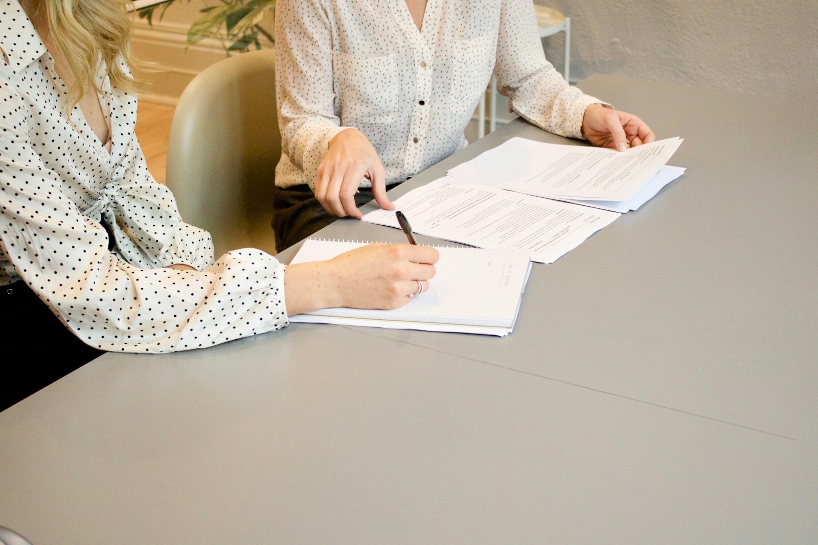 New employee signing onboarding paperwork with a manager